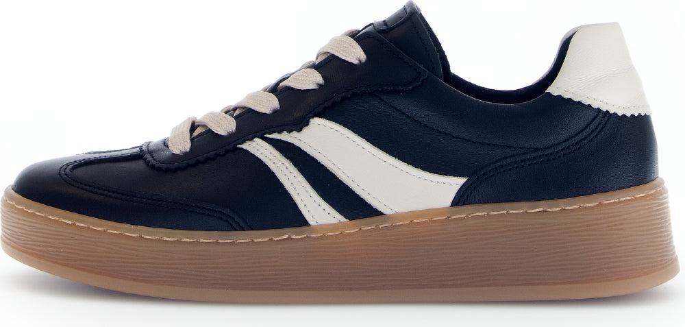 Left side view of black and white sneaker with a brown sole on a white background