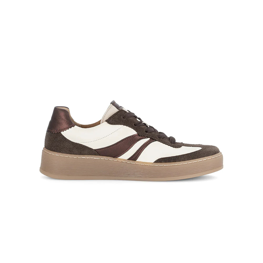 side view of brown and white sneaker on a white background