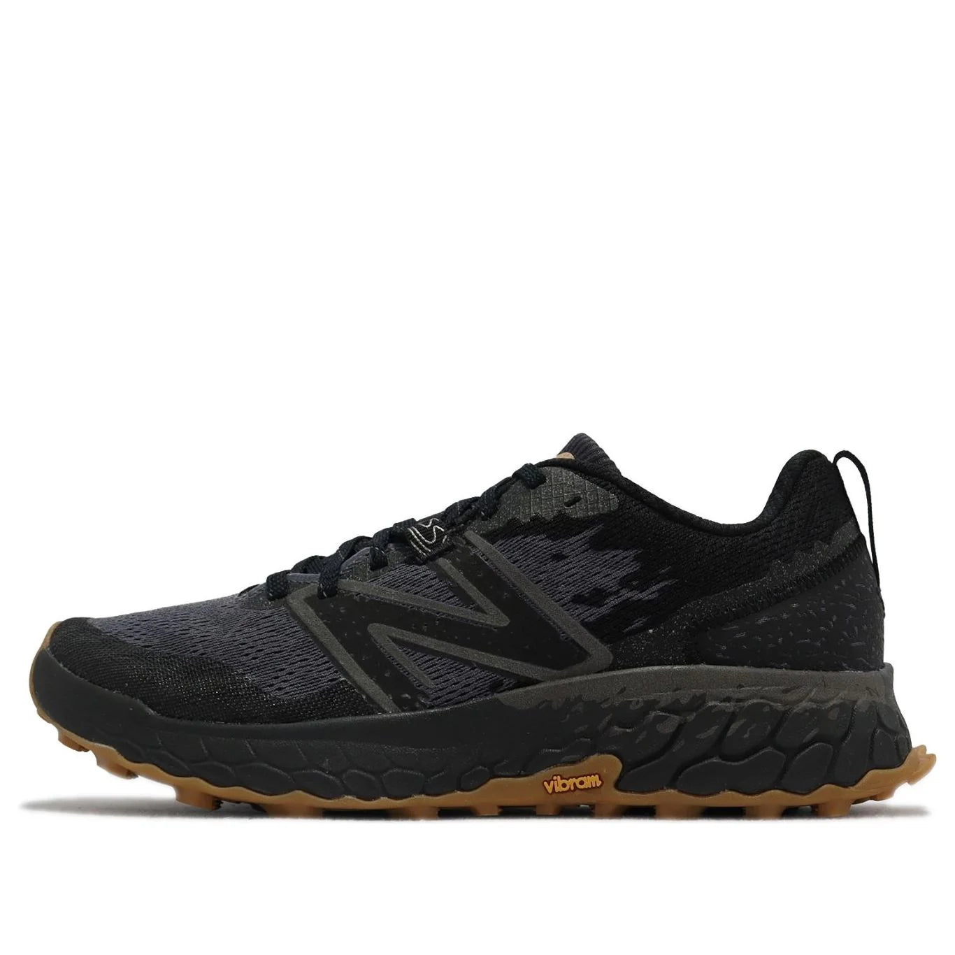 Black running shoe with brown sole on a white background NEW BALANCE