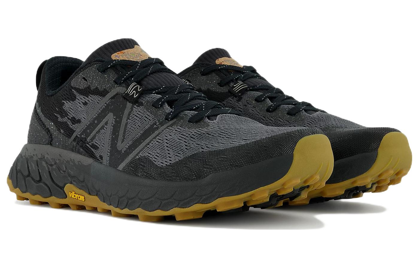 Black and yellow running shoes on a white background NEW BALANCE