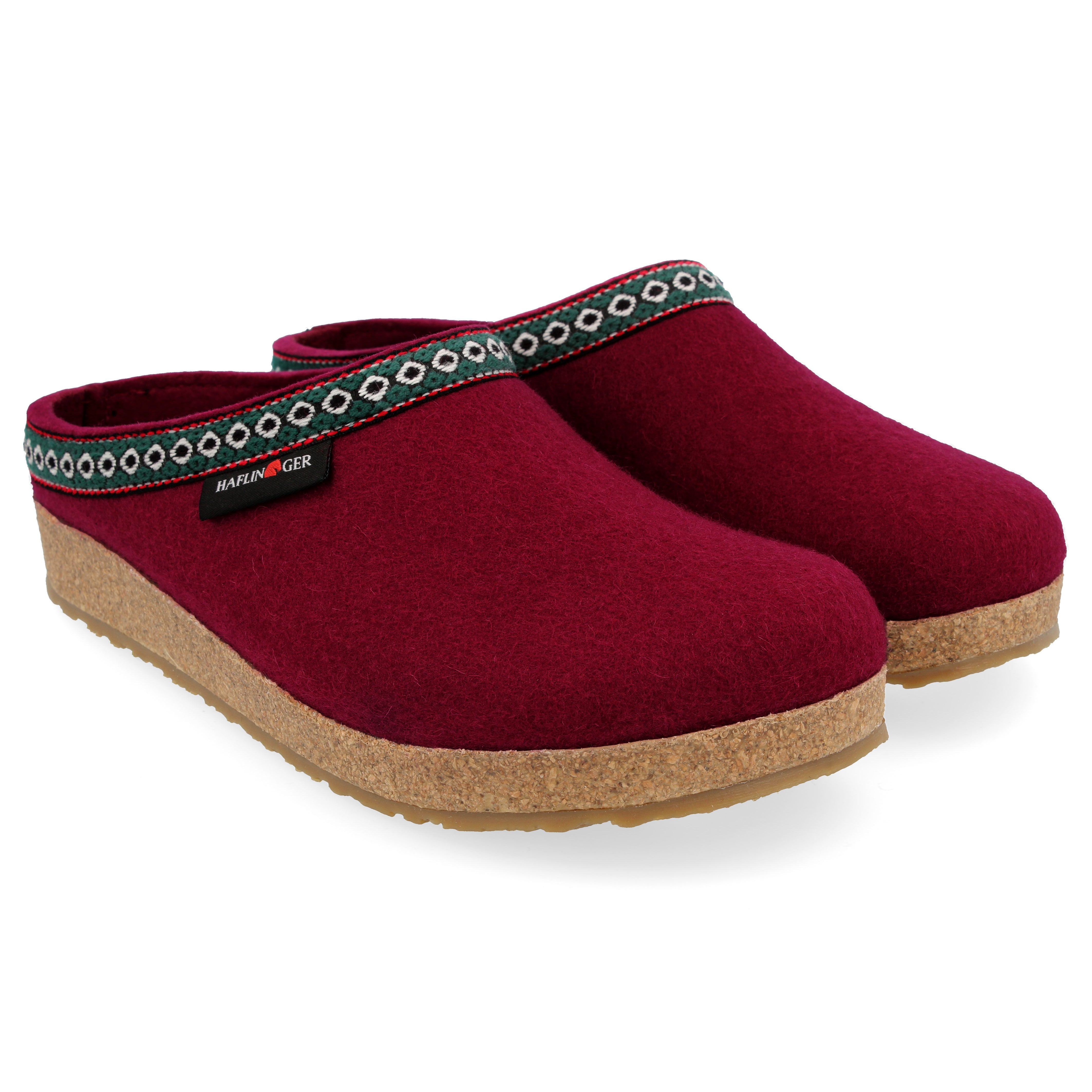 Pair of HAFLINGER  CLASSIC GRIZZLY SLIPPERS red clogs with a brand label on a white background